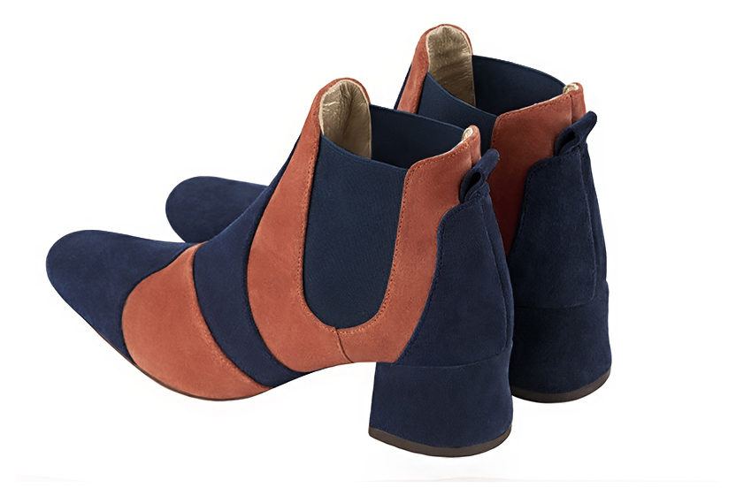 Boots femme : Boots bicolores élastiques sur les côtés couleur bleu marine et orange corail. Bout rond. Petit talon évasé. Vue arrière - Florence KOOIJMAN