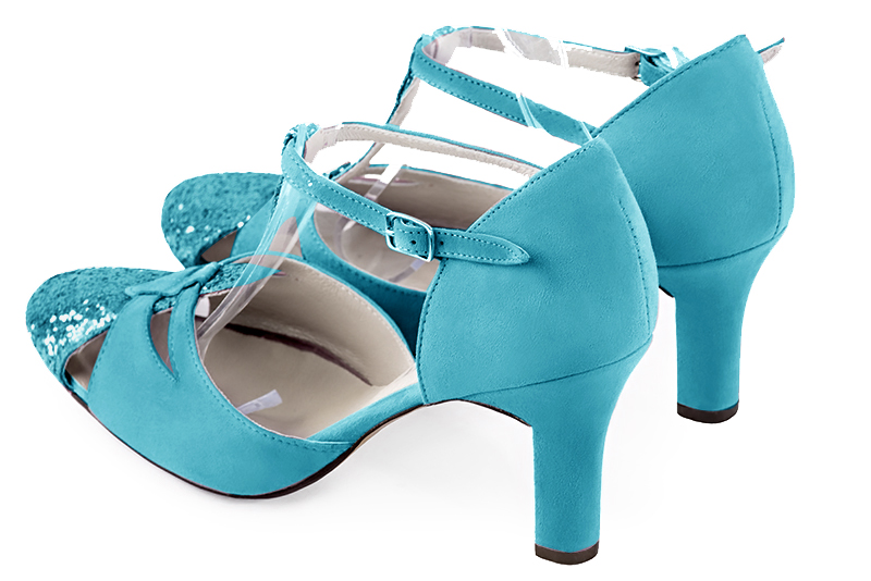 Chaussure femme à brides : Salomé côtés ouverts couleur bleu turquoise. Bout rond. Talon haut trotteur. Vue arrière - Florence KOOIJMAN
