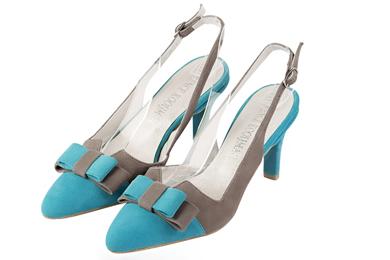 Escarpins habillés, élégants et raffinés, ouverts à l'arrière avec un noeud sur l'avant, coloris bleu turquoise et beige mastic. Bout effilé. Mi-haut à haut. Talon fin. Cérémonie, soirée, cocktail, évènementiel. Personnalisation : Choix des cuirs, 
                des couleurs et des talons. Petites et grandes pointures. - Florence KOOIJMAN